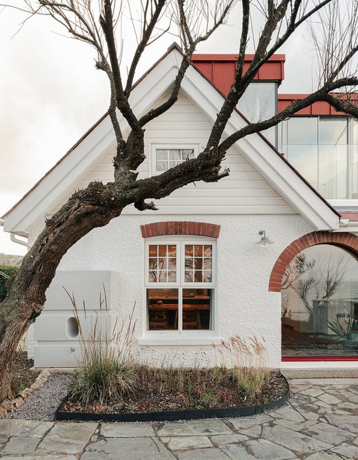 The existing white roughcast rendered facade has been retained.