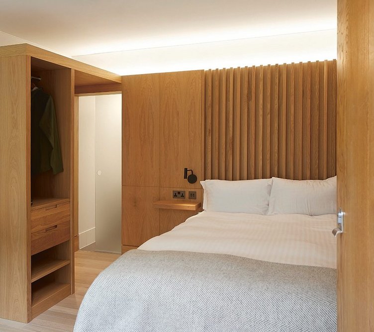 Comfortable and warm en suite bedrooms are fitted out in oak veneer, contrasting with more traditional maple joinery in conference areas.