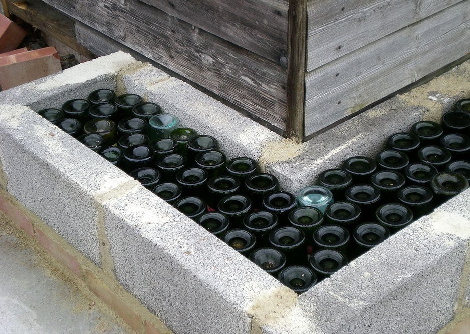 Glass bottles were donated by locals to create the wall structure of the new village hall.