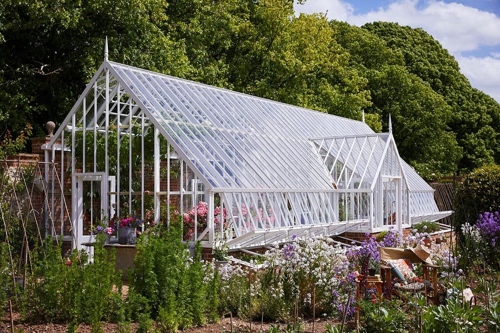 Alitex aluminium three-quarter span, lean-to greenhouse.
