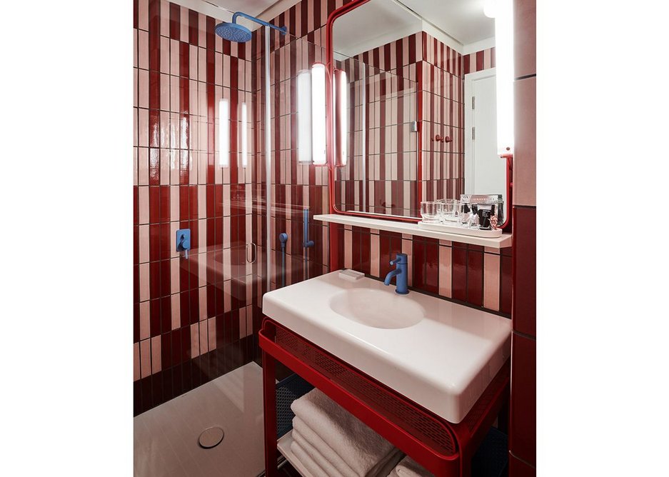 The 70s are referenced on the two-tone striated walls and bevelled edges of the bathrooms.