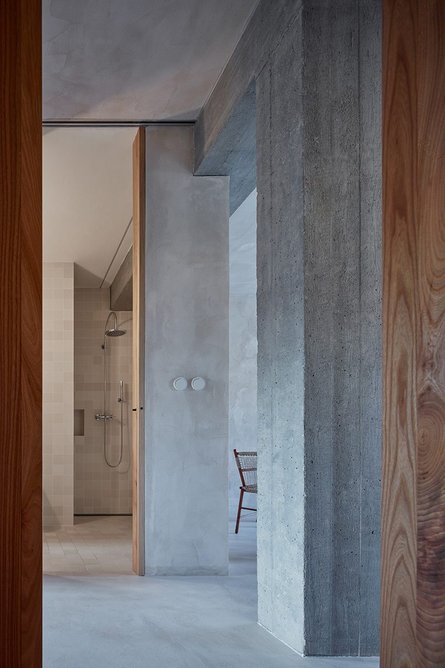 Raw concrete and timber are in material counterpoint throughout.