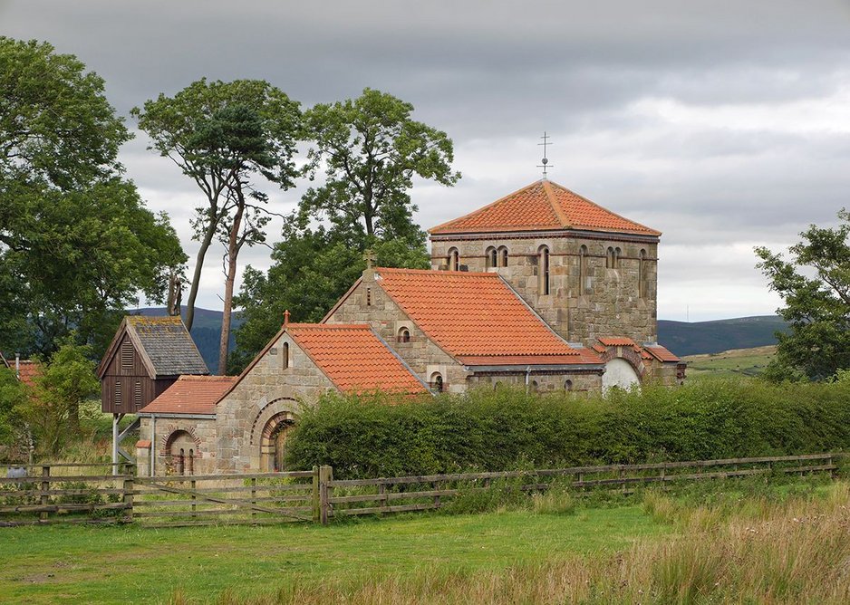 The chapel nestles into the slope in a one-time farmyard.