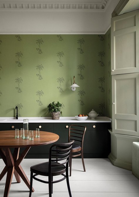 Wall in Lighthouse Palm - Chelsea Green wallpaper. Kitchen cabinets painted in Stable Green 554; window shutters and lower wall, Willow V 535, both Architects' Eggshell, Paint & Paper Library.
