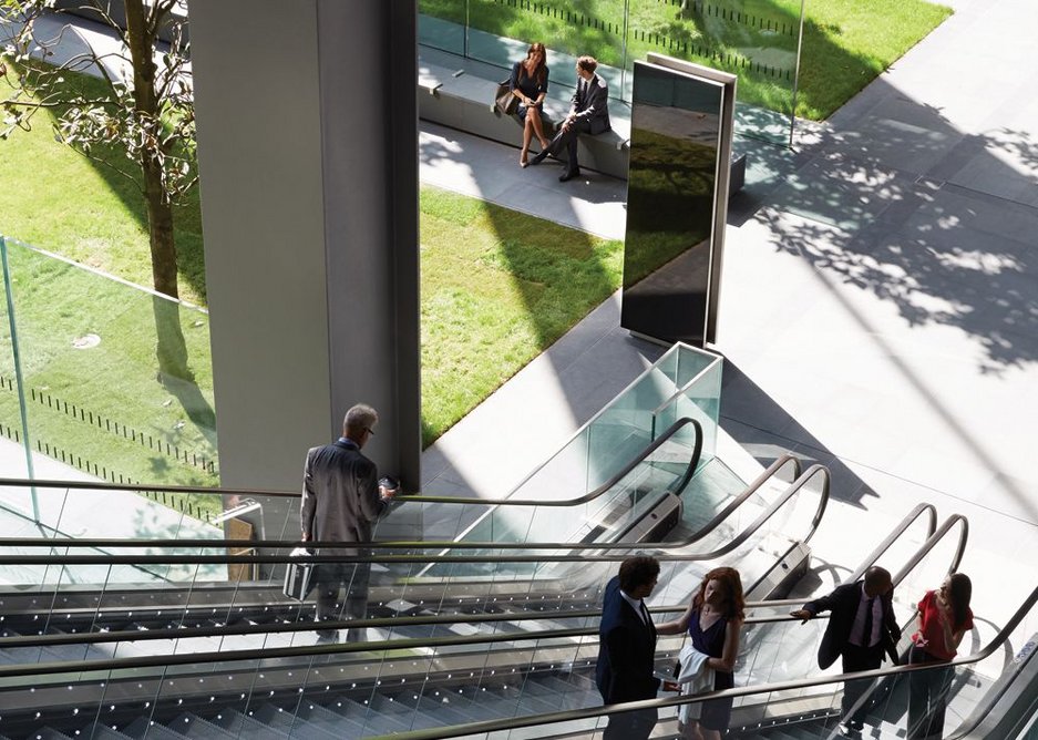 Looking down the escalators into the public space below the building.