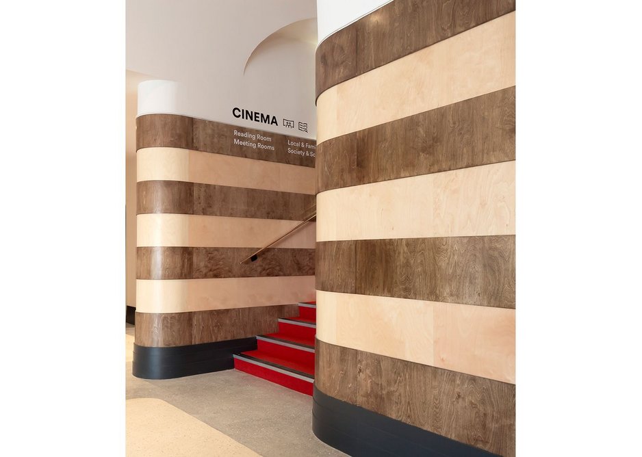 Entering Storyhouse from Town Hall Square you are drawn up into the cinema by reinstated curving stripes of ply. Chester Storyhouse, Bennetts Associates.