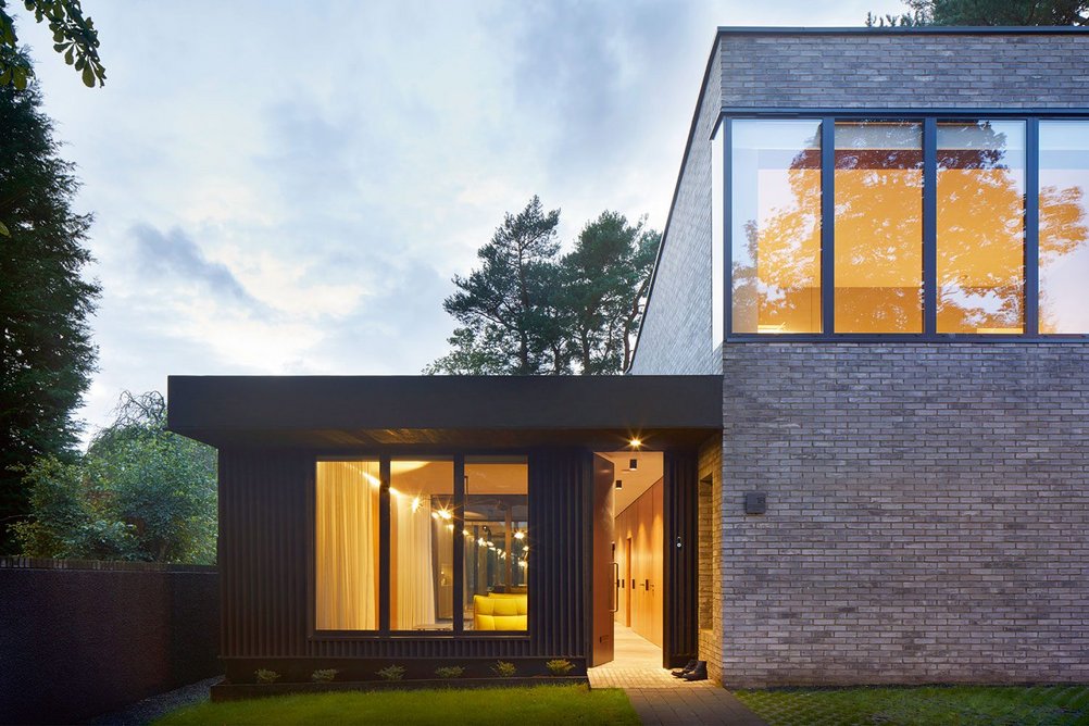 The pavilion holds the main living and dining areas, with the brick block forming more intimate sleeping spaces.