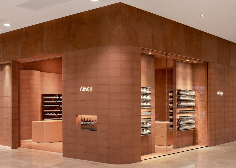 Blockwork walls tinted with red sandstone and honey-coloured resin sink units lend warmth to Aesop’s Westfield store.