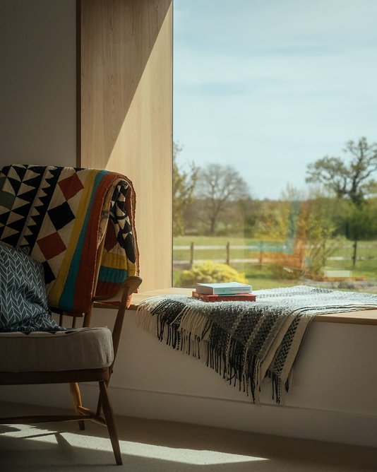 The bay window forms an oak-lined reading nook.