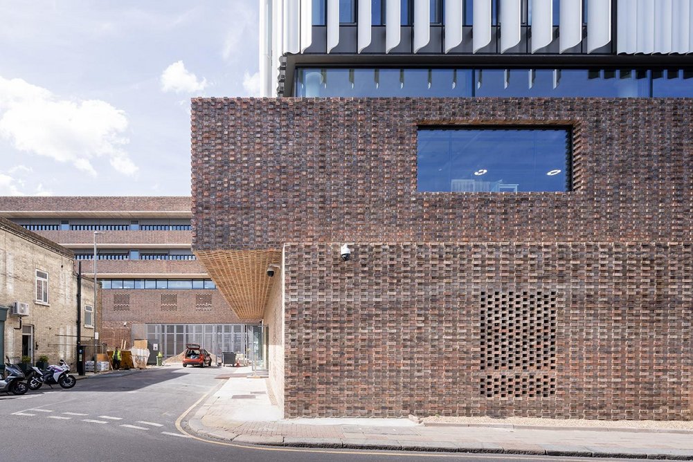 The Royal College of Art’s Studio Building with the tower in the foreground, aluminium fins atop a brick base.
