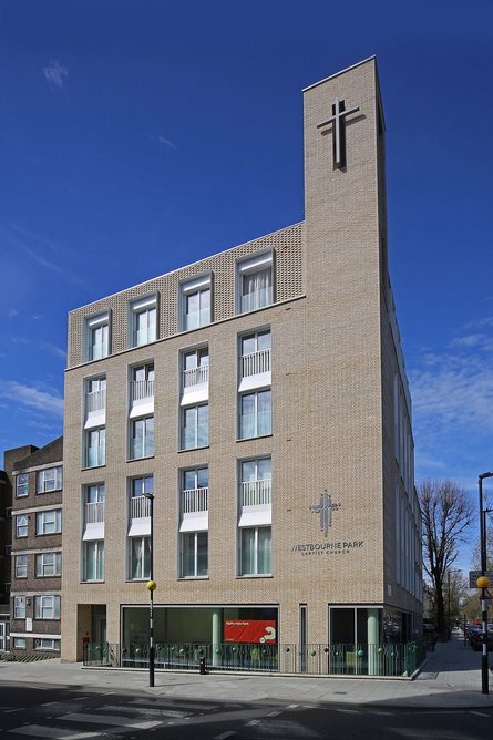 A campanile emphasises the church's position at the heart of the scheme.