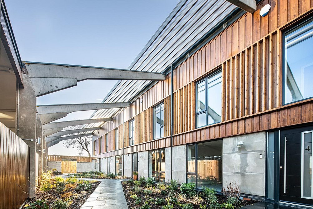 View of the front garden courtyard which is shared between all newly converted homes by Peak Architects.