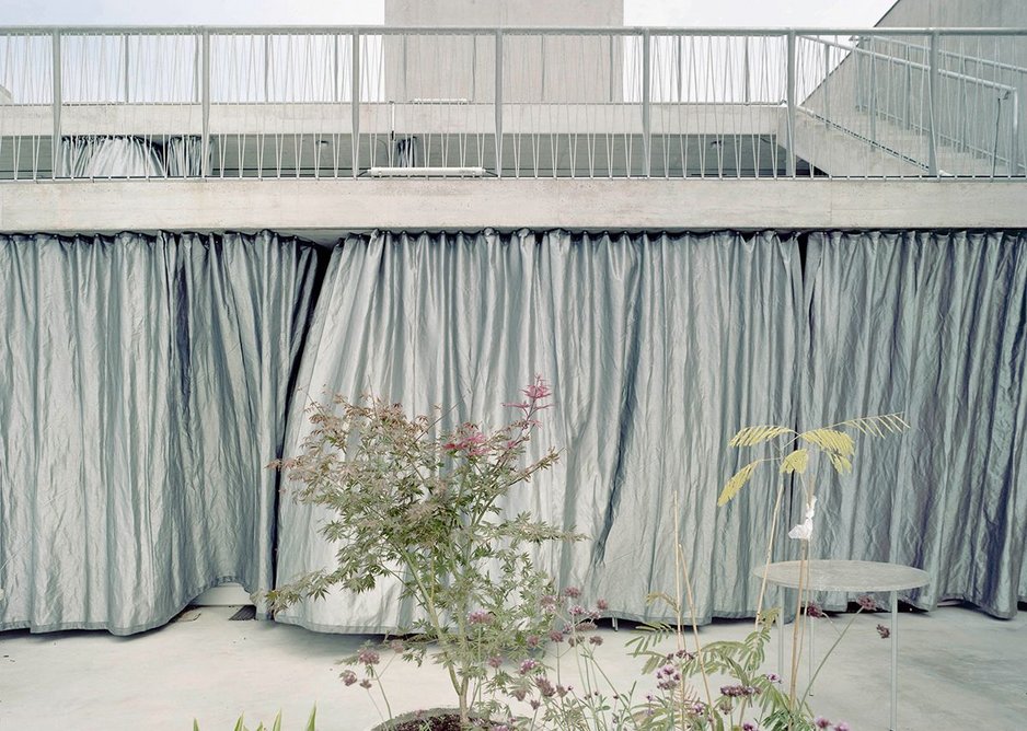 Heavy duty silver geotextile curtains act as a solar shade, allowing a diaphanous light into the interiors.