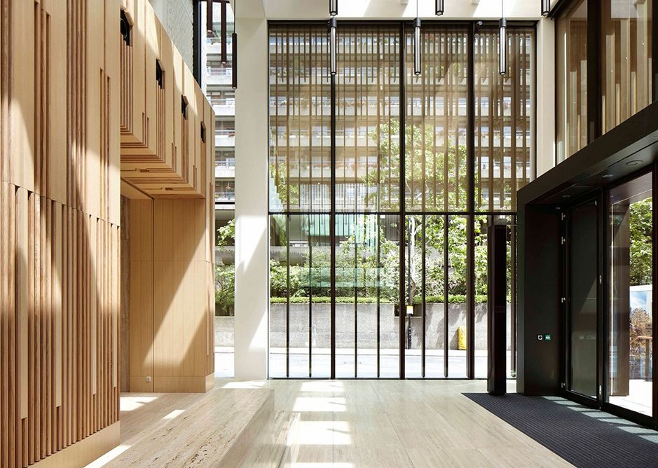 The new Salters’ Hall reception, looking north. Now flooded with light, it greets the visitor with a rich palette of ash and travertine with elegant, slender light fittings.