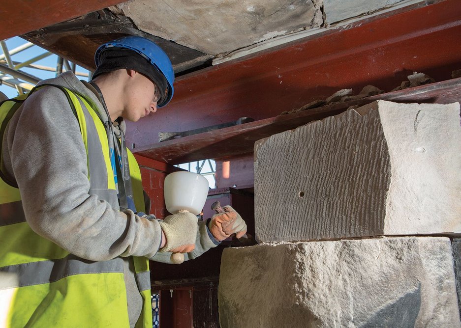 An apprentice stone mason tools new Giffnock sandstone for the west gable wall.