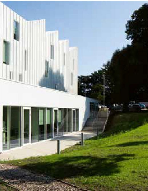 The informal, garden side of the building reverts to more conventional, single-skin cladding.