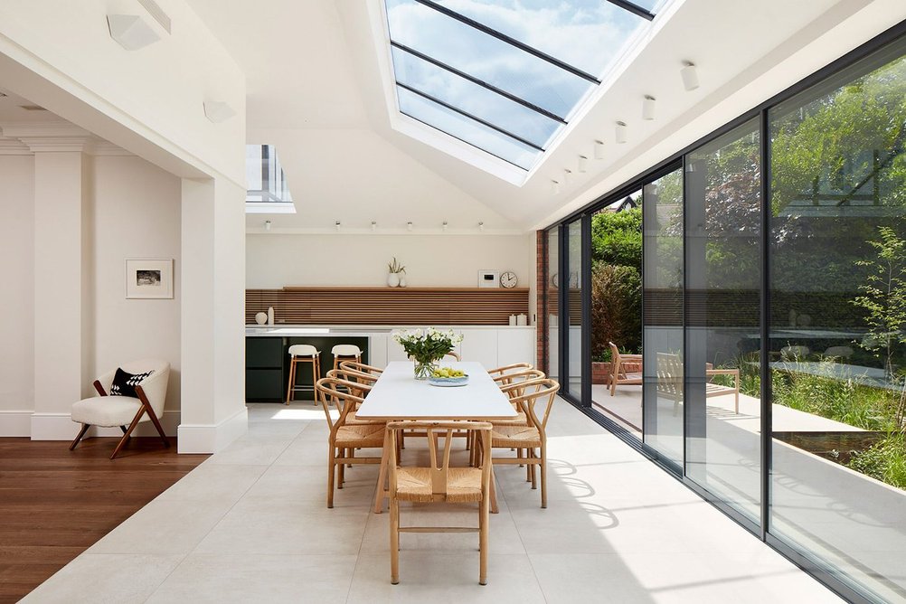 Rooflight glazing bars match the sliding door and fixed light window frames below.