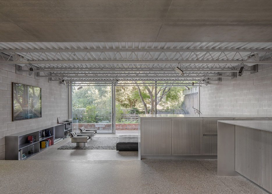 View from Reciprocal House through to Foster Associates extension with bespoke furniture. Credit: Schnepp Renou