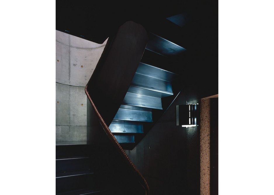 Elliptical staircases are the dark heart of the homes, drawing people up to the light.