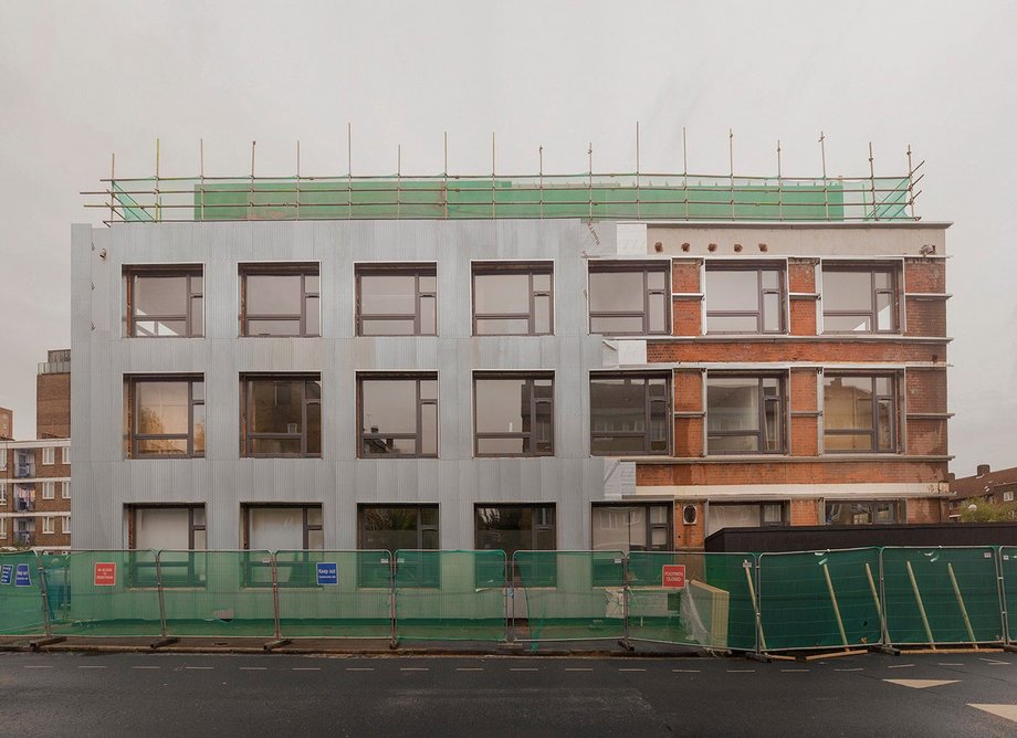 Deborah House Studios under construction, with corrugated metal facades as part of a retrofit by Sarah Wigglesworth Architects.