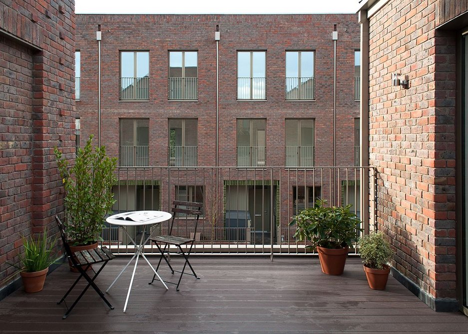 First floor terraces create contemporary relationships with the opposite side of the street while brick ‘blind window’ details suggest a previous history.