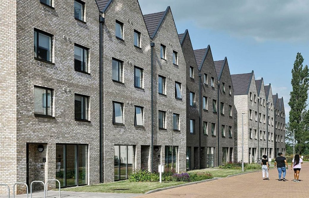 Velfac doors and windows at Westwood Student Mews, Coventry. Dark brown external aluminium frames complement cream and grey brickwork.