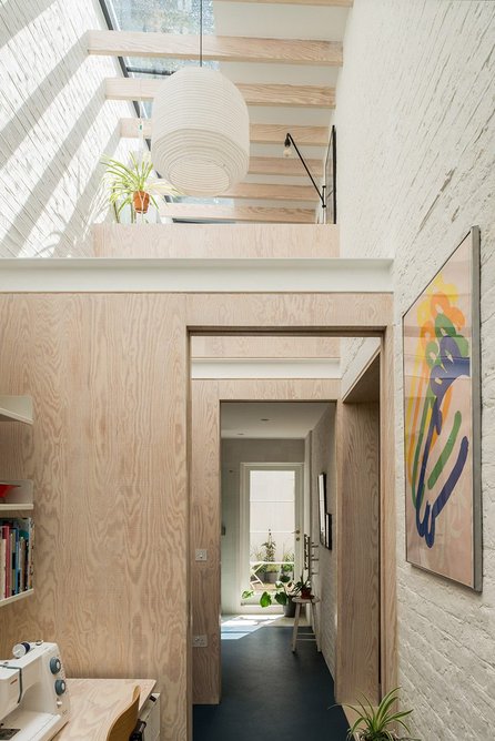 'The volume reaches up for daylight, channelling it down into the existing house through a central opening connecting the rooms.'