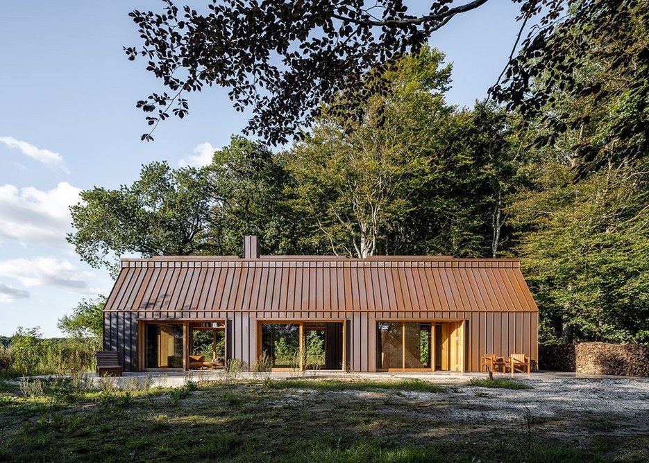 The copper standing seam cladding has already turned a rusty brown as it evolves towards green.