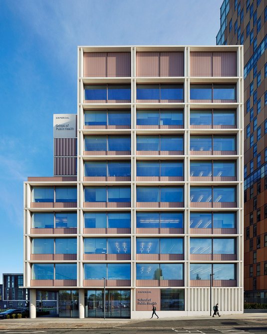 The building mediates between a high-rise residential block and Victorian terraces.