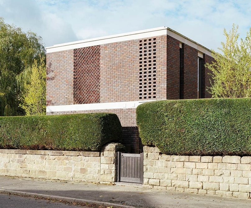 Set behind an existing garden wall, the house is an unobtrusive presence on a quiet street.
