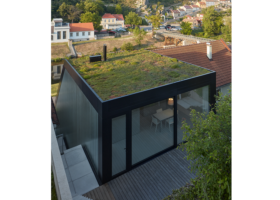 The green roof extends over the building.