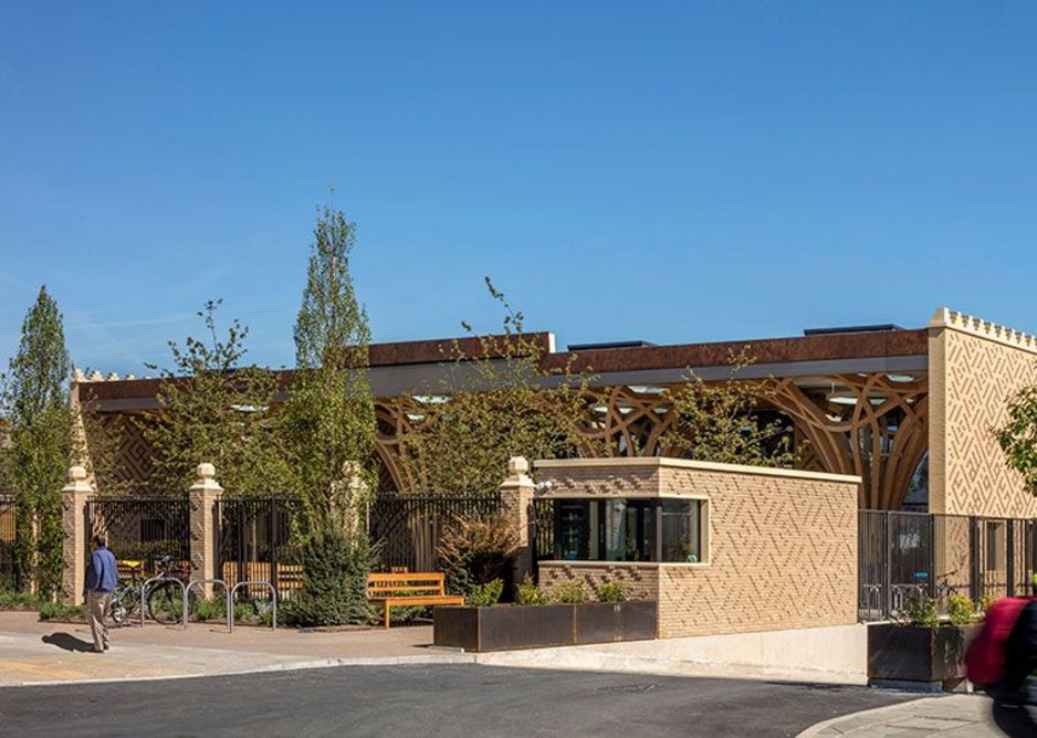 The building is low rise and spread across the site. Rather than demanding attention from the street, it is instead experienced internally. A colonnade of structural timber columns and portico form the facade, set behind a public garden