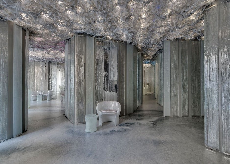 The interior combines a cloud-like ceiling with glass panels and a digitally printed sintered stone floor