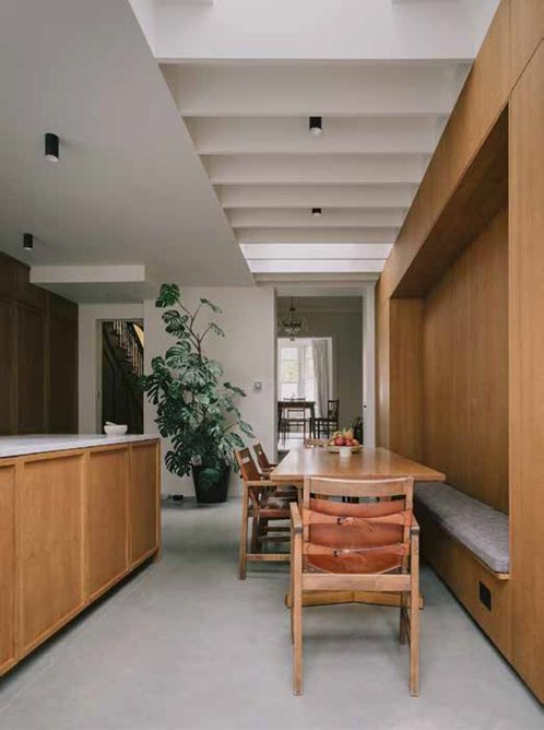 Timber fins diffuse top light over the dining area.