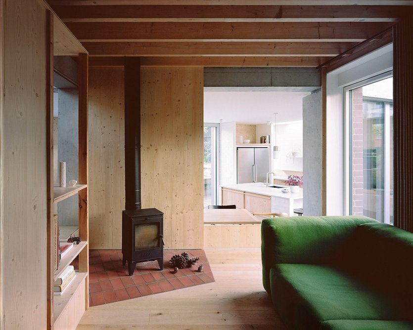 The snug, where pine sliding partition walls allow the space to open to the kitchen behind the dining banquette.
