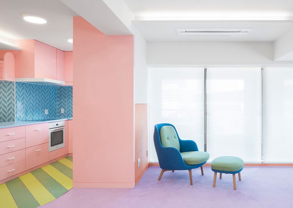 Baby pink pastel seems almost sedate juxtaposed against other colours in the space.
