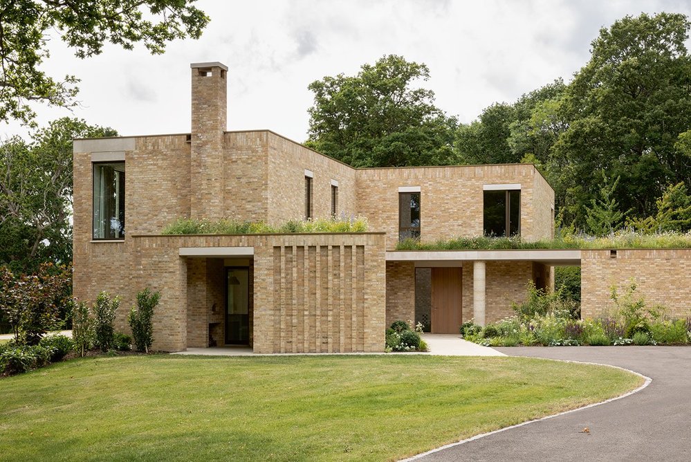 The main approach from behind is more informal and conventionally contemporary with stacked, slipped volumes.