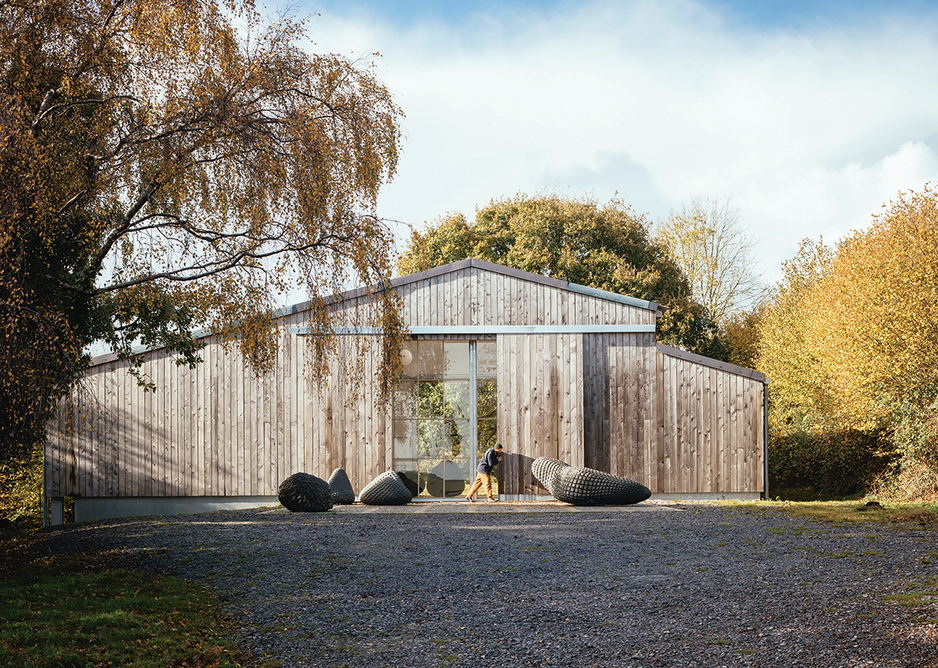 The track leading to the Art Barn enters a 100-acre broadleaf wood cloaking the north bank of the River Teign and arrives at the building’s gabled east facade.