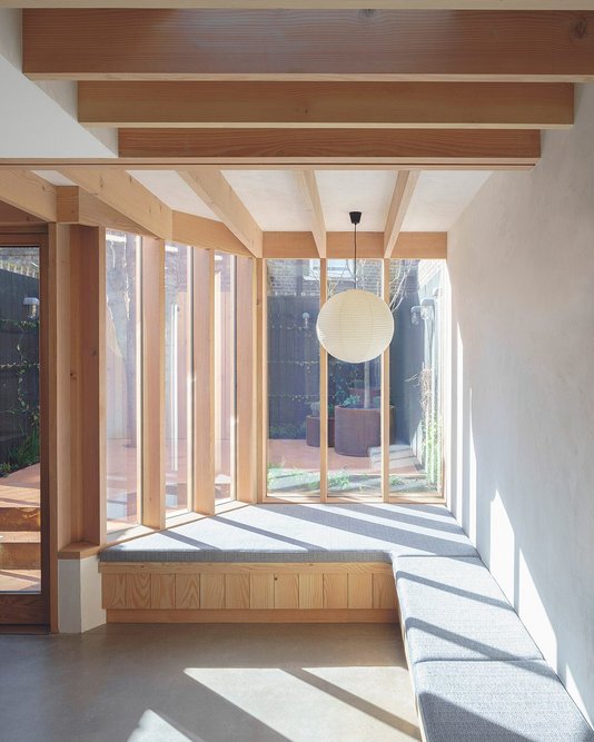Tall glazed doors and deep-framed timber windows direct natural light.