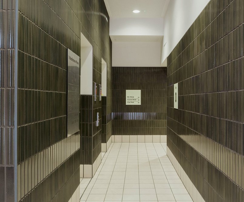 Dark green, grooved lobby tiles exceed standard Peabody specification.