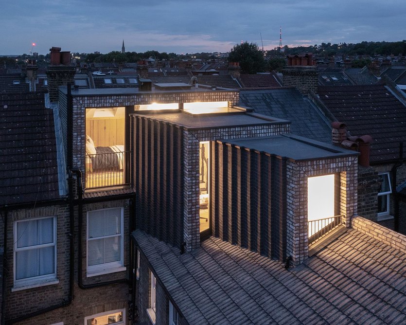 At night Stepped Loft glows from within, and the stepping brickwork gently catches the light.
