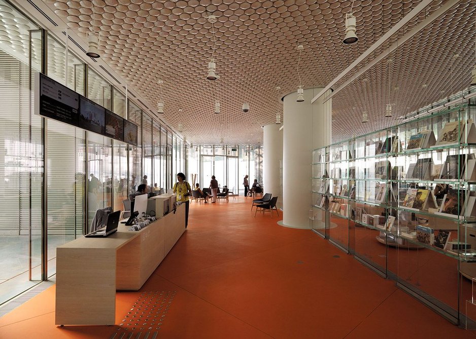 The iridescent ceramic discs appear inside as the soffit to the shop/restaurant. Marine-grade steel cladding supports abound.