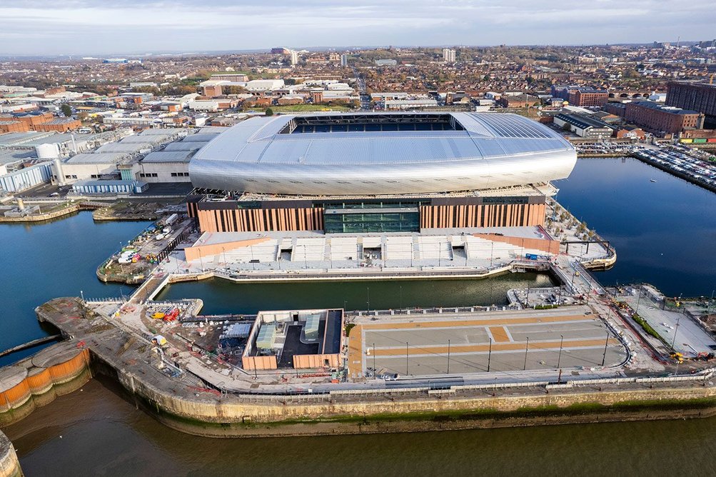 West facade.  Bringing 1.4m extra annual visitors to the  city, the stadium will aid regeneration of  the northern docks,  extending 2.3km along the Mersey.