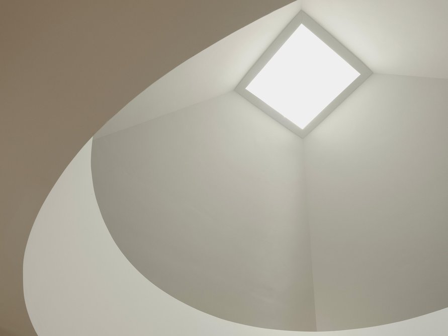 Light softly filters down into the dining area from a single rooflight.