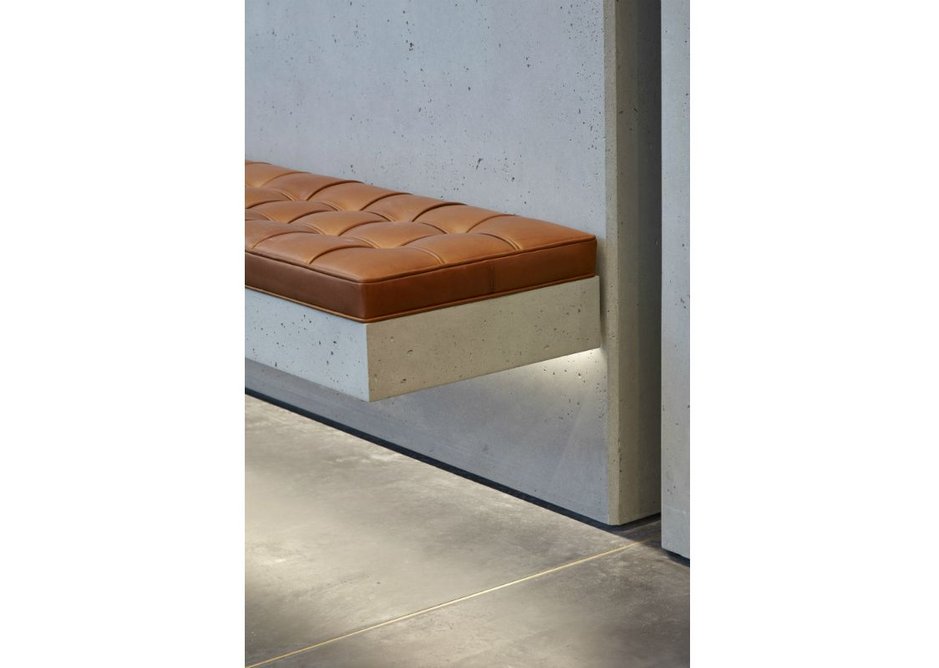 Underlit bench seating showcases polished concrete at One Bedford Avenue, Fitzrovia, London. Architect Bennetts Associates.