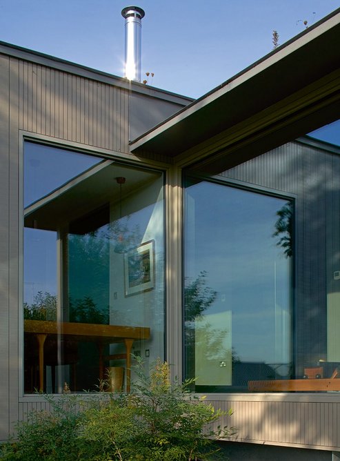Stained larch cladding comprises a mix of wide sawn and narrow planed boards.