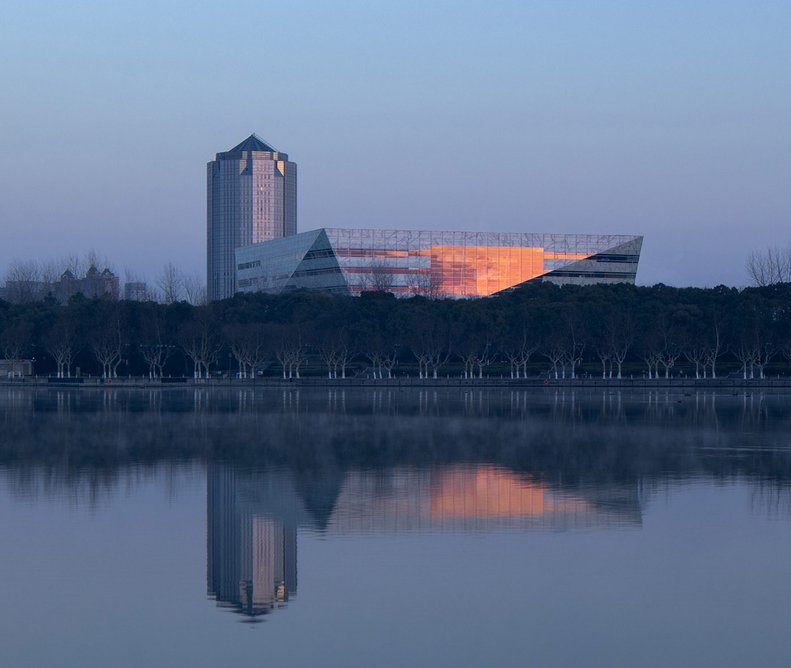 The library shimmers on the edge of Shanghai’s Century Park as if levitating above the trees.