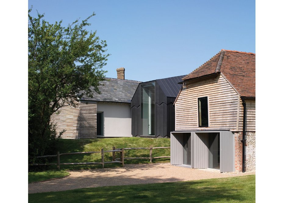 The refurbished cart lodge, seen at the front, serves as the entrance to the museum