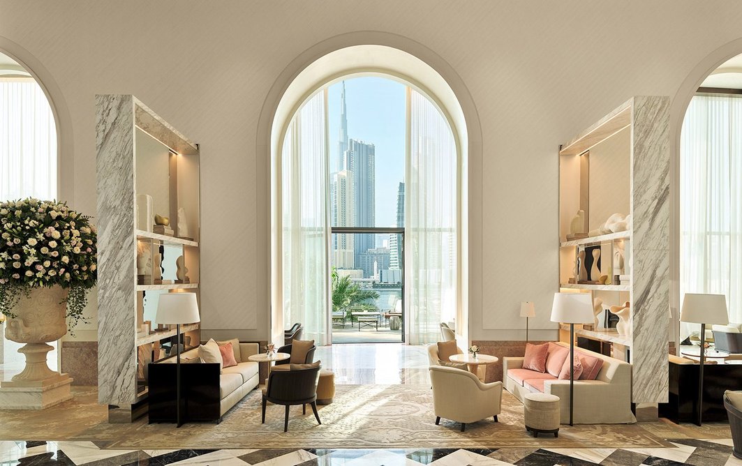 Designed by Gilles & Boissier, the lobby features an arch motif and rich palette including pink marble and alabaster.