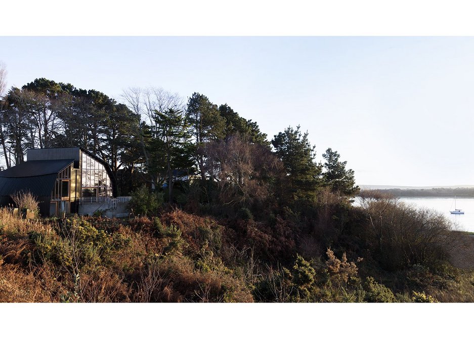 Houseboat, Poole, Dorset in its setting as the land falls away to the sea.